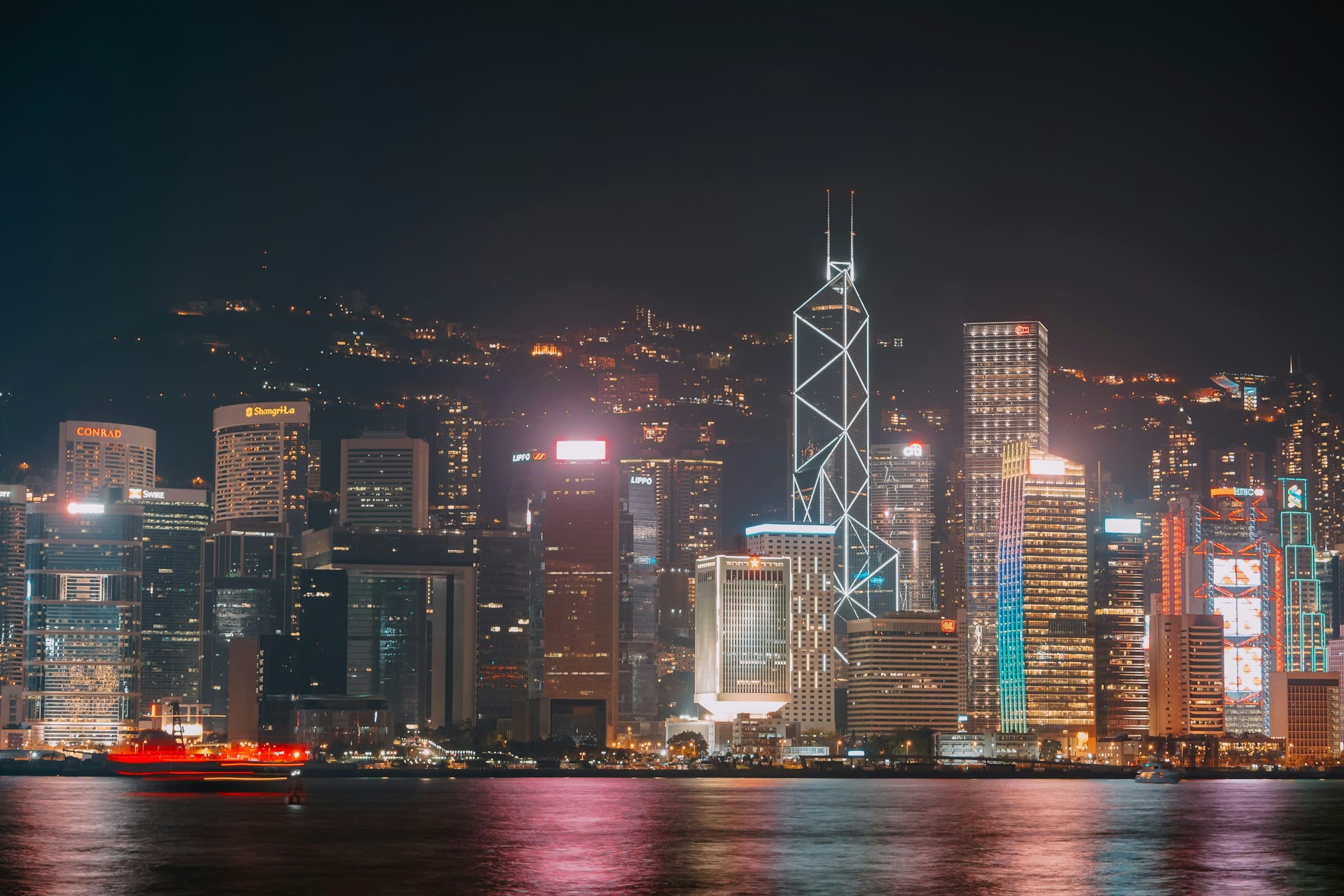 Hong Kong Central skyline lit up at night across Victoria Harbour