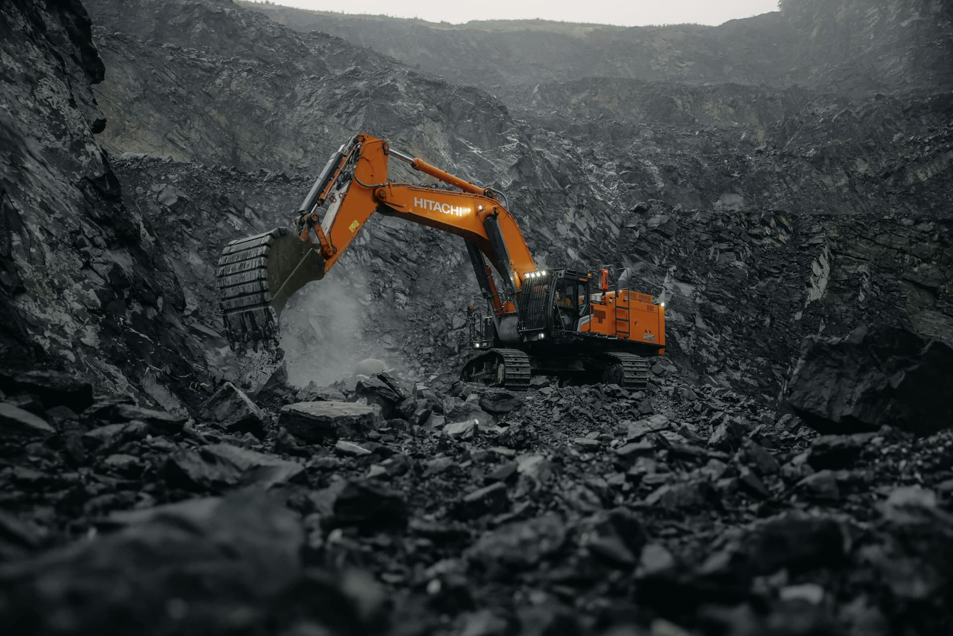 Haul trucks working on the terraced benches of an open-pit mine