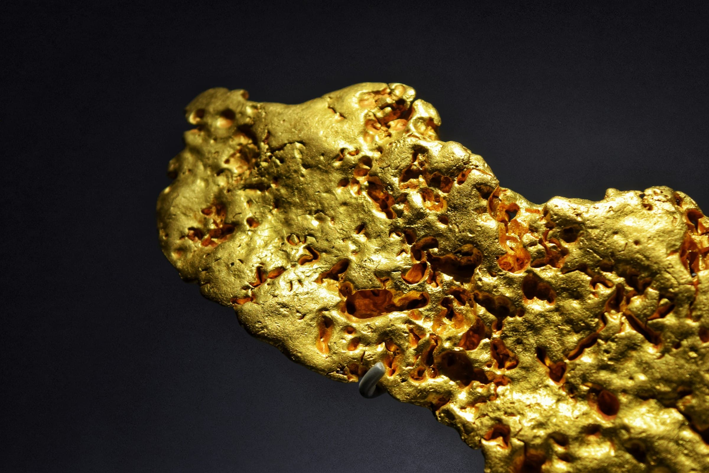 Raw gold nugget on a dark background